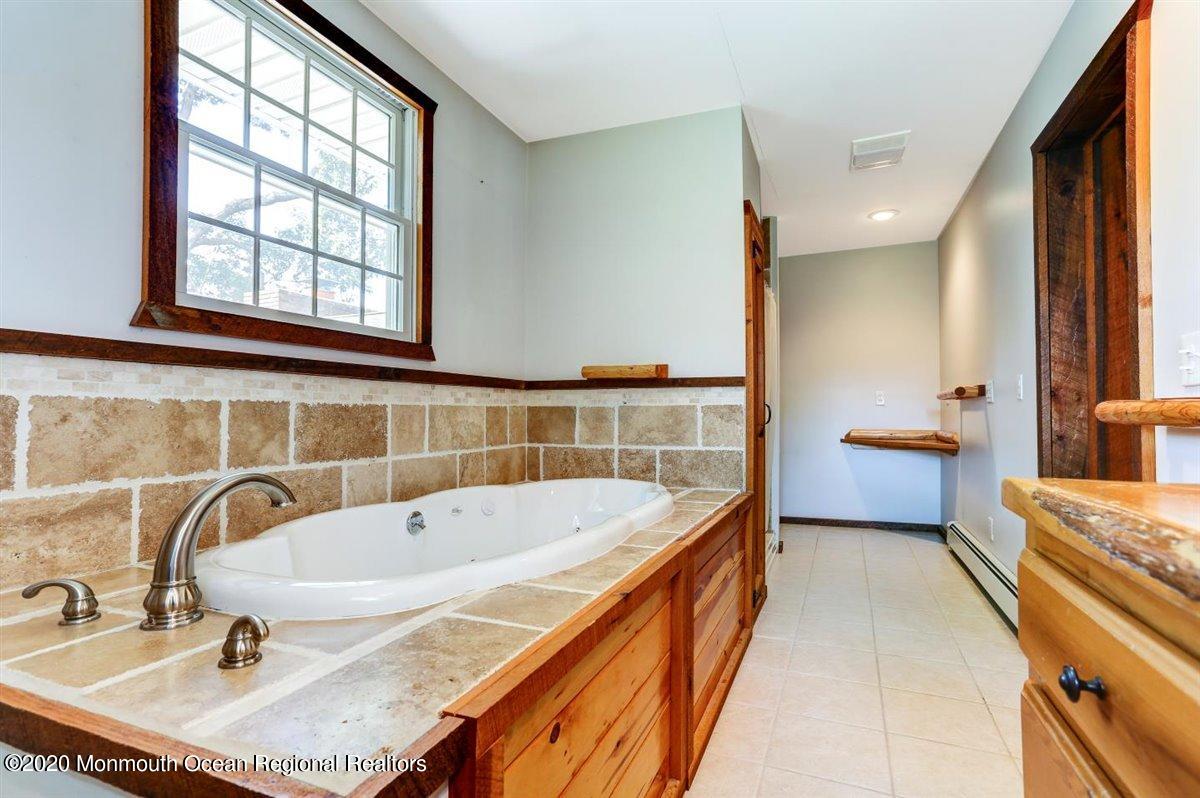 58 Ridge Road Branchville, NJ 07826 - Photo 27 of 51 a bathroom with a tub sink and mirror