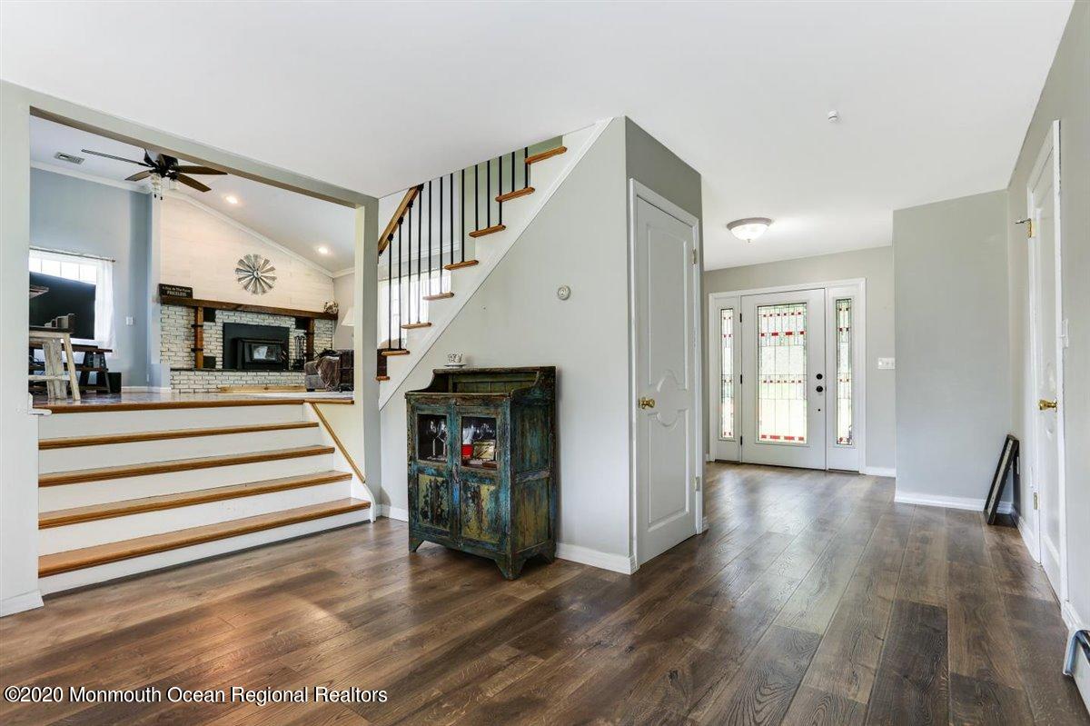 58 Ridge Road Branchville, NJ 07826 - Photo 5 of 51 a view of a livingroom with wooden floor and a fireplace