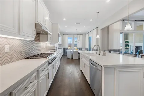 a spacious bathroom with a double vanity sink a mirror and a bathtub