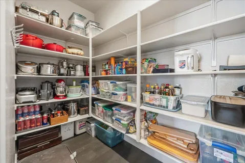 a large kitchen with stainless steel appliances granite countertop a lot of counter space and wooden floors