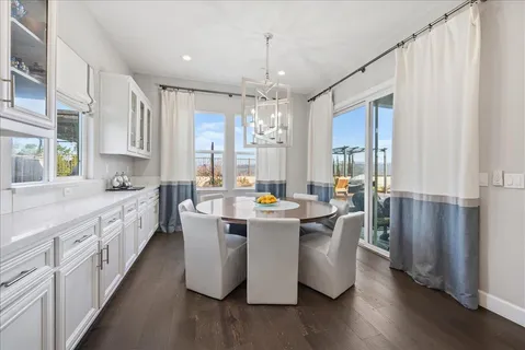 a living room with furniture a book shelf and a flat screen tv