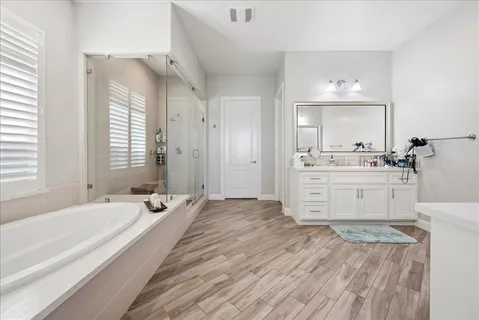 a spacious bedroom with a bed and a couch