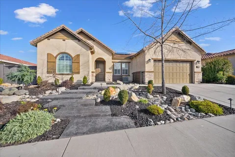 a front view of a house with garden