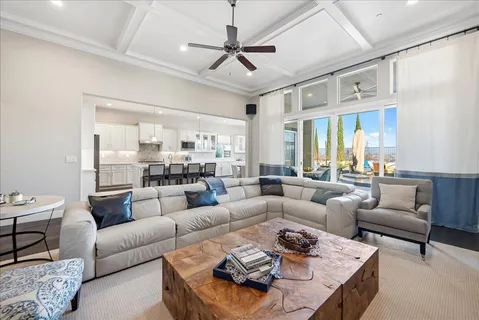 a kitchen with stainless steel appliances kitchen island granite countertop a table chairs and a refrigerator