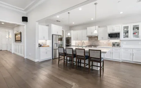 a kitchen with stainless steel appliances a sink stove and cabinets