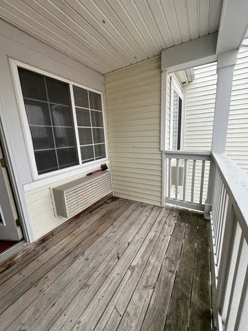 a view of a balcony with wooden floor