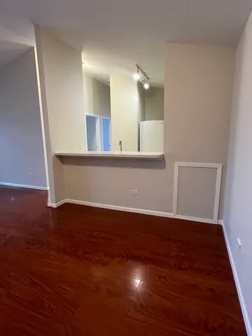 a view of a room with wooden floor and staircase