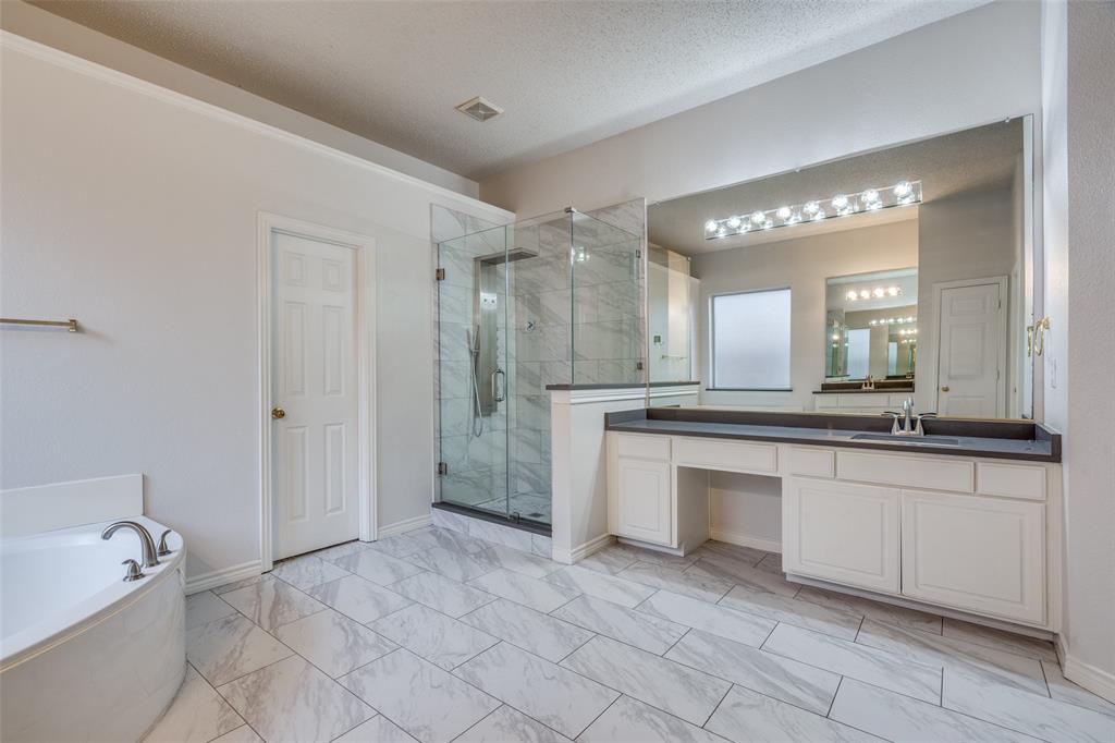 3421 Neiman Road Plano, TX 75025 - Photo 18 of 40 Full bathroom with marble finish floors, a shower stall, a bath, and vanity