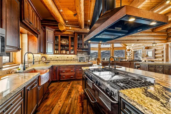 a kitchen with stainless steel appliances granite countertop a stove sink and cabinets