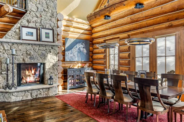 a dining table with chairs and fireplace