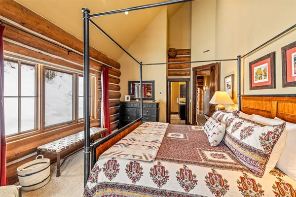 a bed sitting in a bedroom next to a window