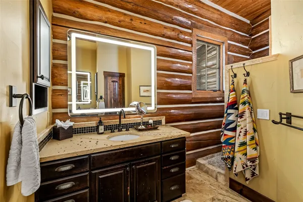 a bathroom with a sink and a mirror