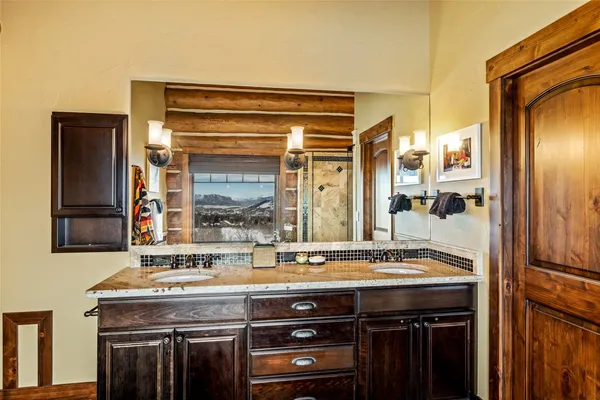 a bathroom with a granite countertop sink and a mirror