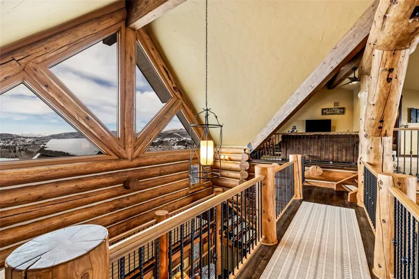 a living room with furniture a flat screen tv and a large window