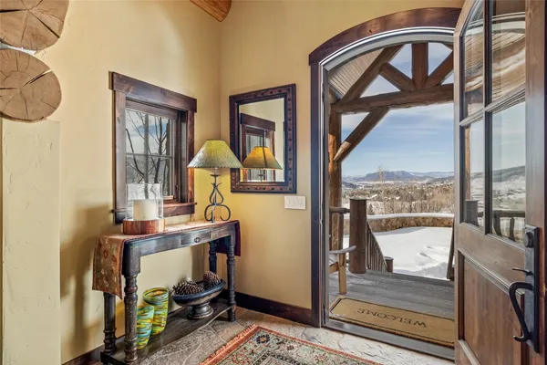 a view of a balcony with furniture and front door