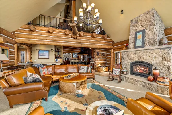 a living room with fireplace furniture and a fireplace