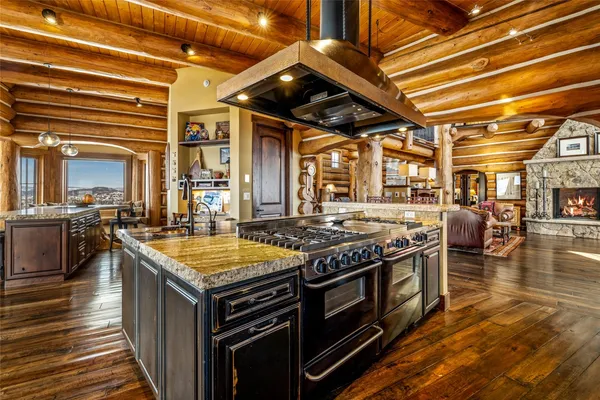 a kitchen with stove and wooden cabinets