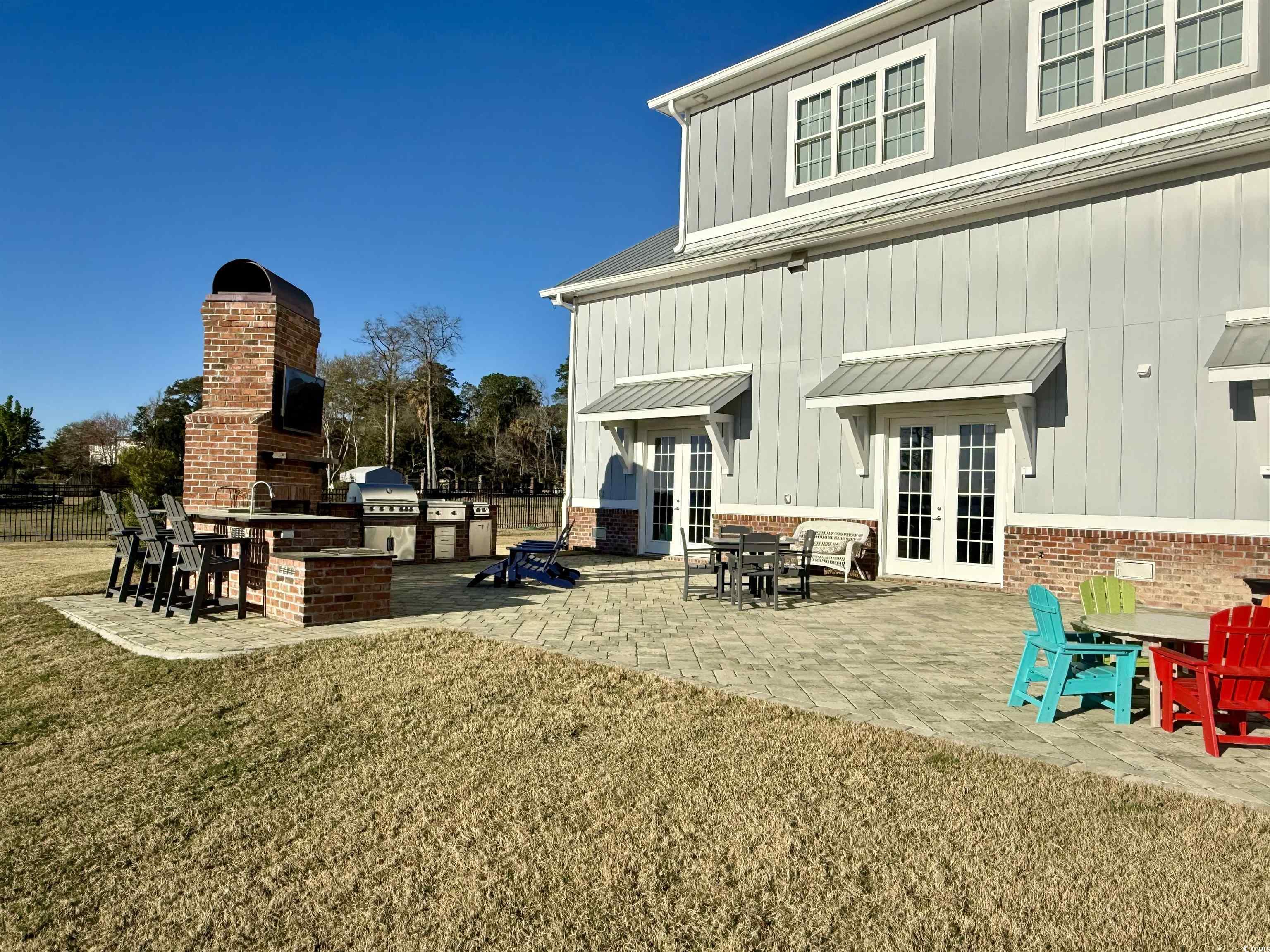 2425 South Bay Street Georgetown, SC 29440 - Photo 38 of 40 Back of house with a sink, french doors, exterior kitchen, a fireplace, and a patio area