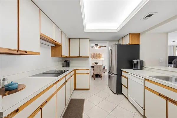 a spacious bedroom with a bed and a dresser