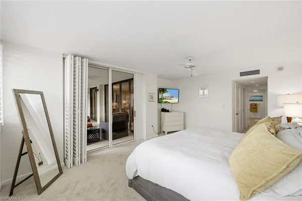 a bedroom with a bed and a couch