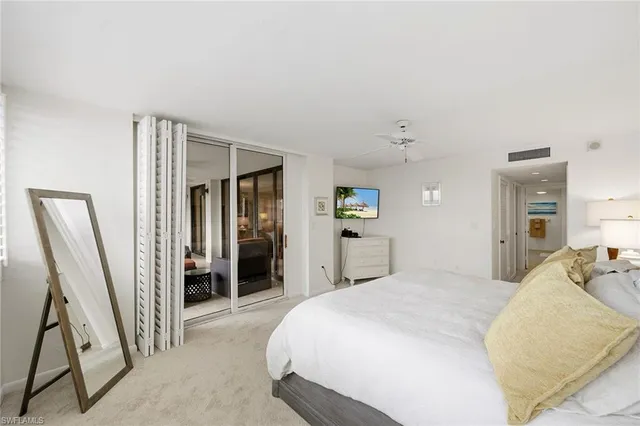 a bedroom with two beds and a large window