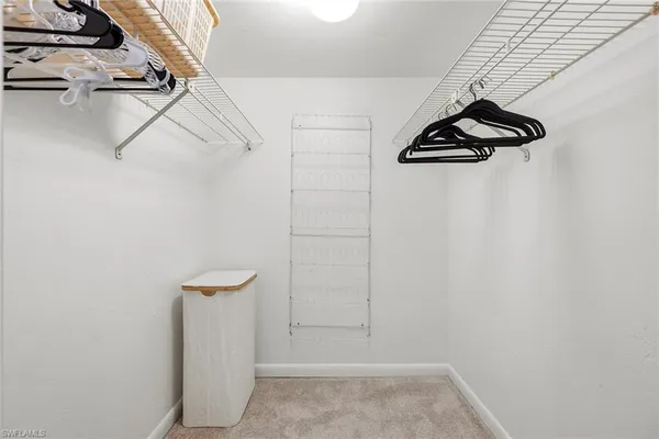 a spacious bathroom with double sink a mirror and shower