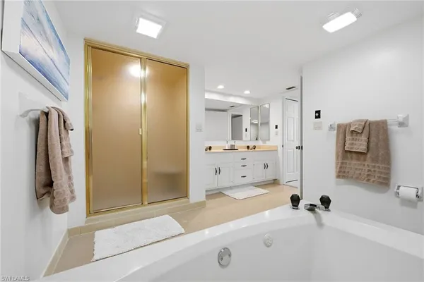 a bathroom with double vanity sink and mirror