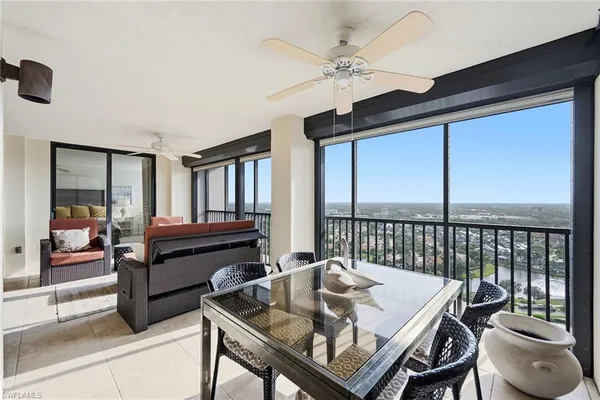 a balcony view with a large window and wooden floor