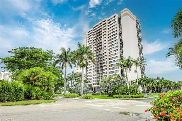 a living room with furniture a large window with wooden floor
