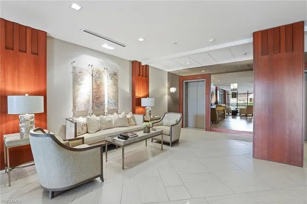 a living room with furniture a rug and a large window