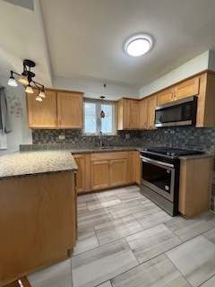 2900 East 101st Street Chicago, IL 60617 - Photo 11 of 27 a kitchen with stainless steel appliances granite countertop a stove a sink and a microwave