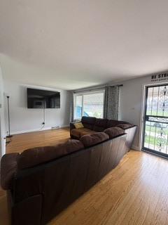 2900 East 101st Street Chicago, IL 60617 - Photo 6 of 27 a living room with a couch and a flat screen tv