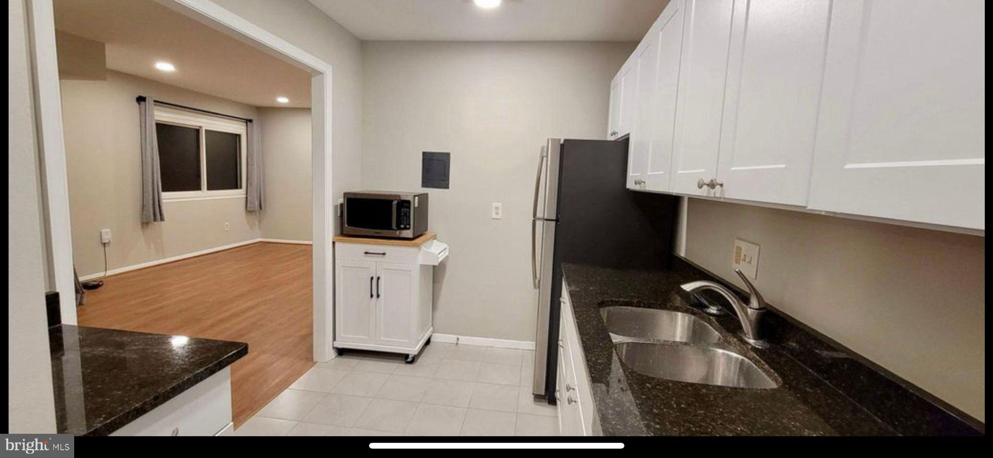 2908 Kings Chapel Road, Unit 3/10 Falls Church, VA 22042 - Photo 5 of 7 a kitchen with stainless steel appliances granite countertop a sink refrigerator and microwave