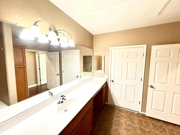 a spacious bathroom with a double vanity sink and a mirror