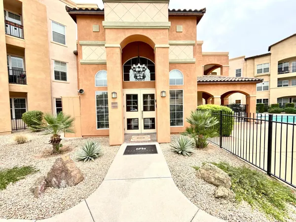 a view of a brick house with potted plants