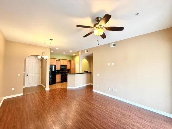 a view of a kitchen with a sink and a refrigerator