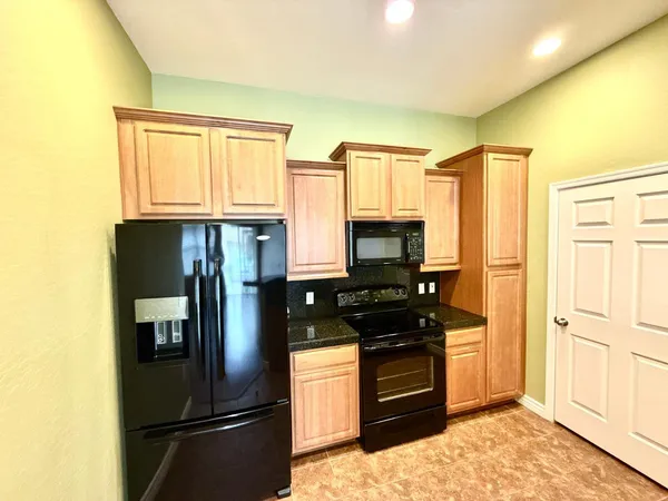 a kitchen with stainless steel appliances a refrigerator stove and microwave