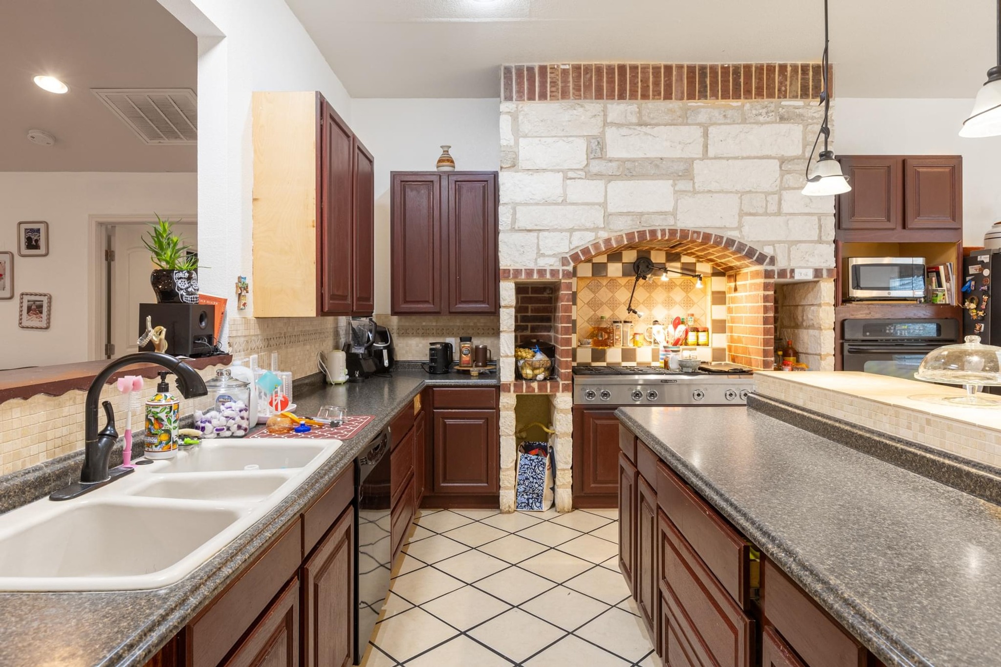 176 Old Lexington Road, Unit C Elgin, TX 78621 - Photo 13 of 31 a kitchen with kitchen island granite countertop a sink stove and cabinets