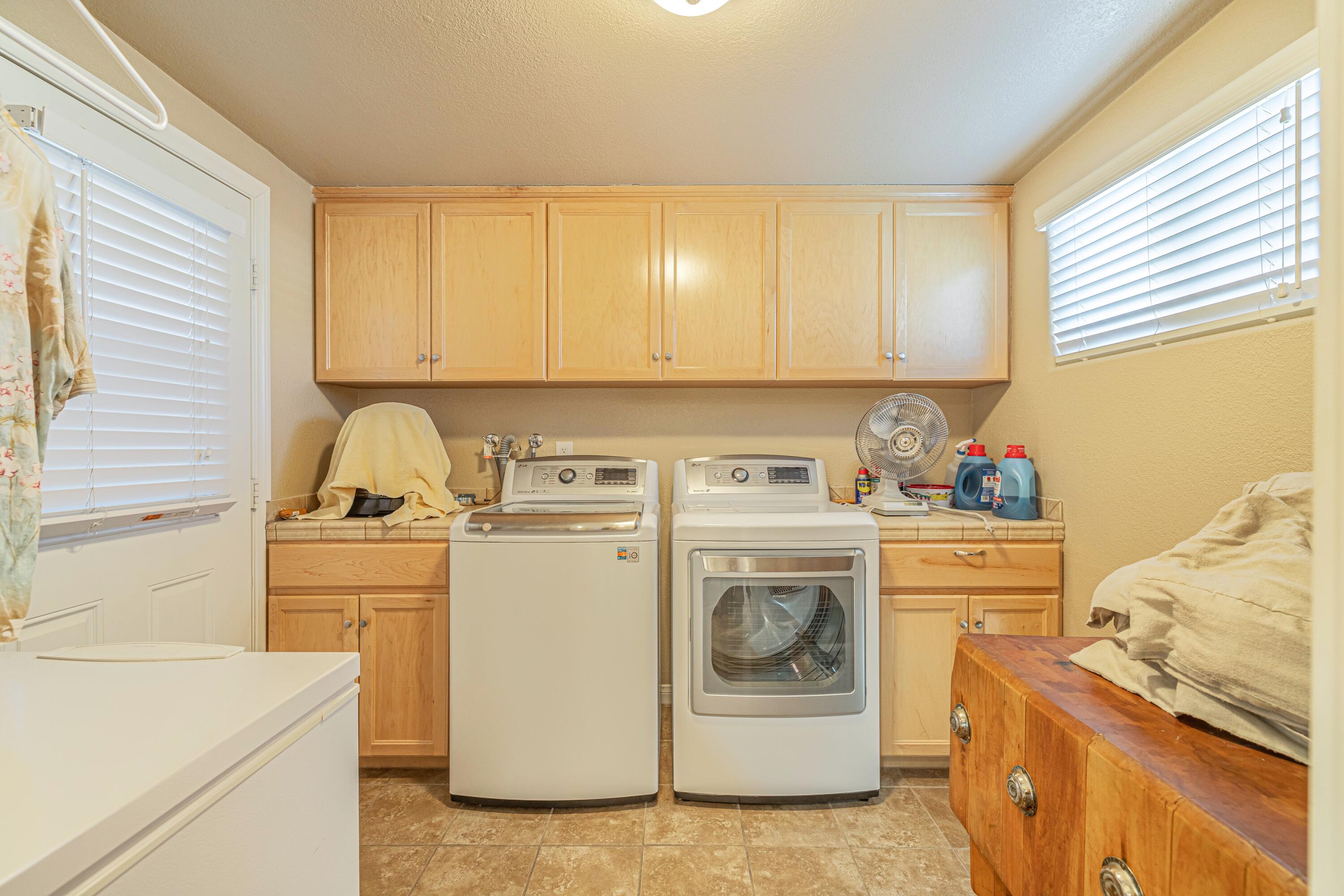 2153 West Ave K8 Lancaster, CA 93534 - Photo 11 of 31 a view of a storage and utility room with washer and dryer
