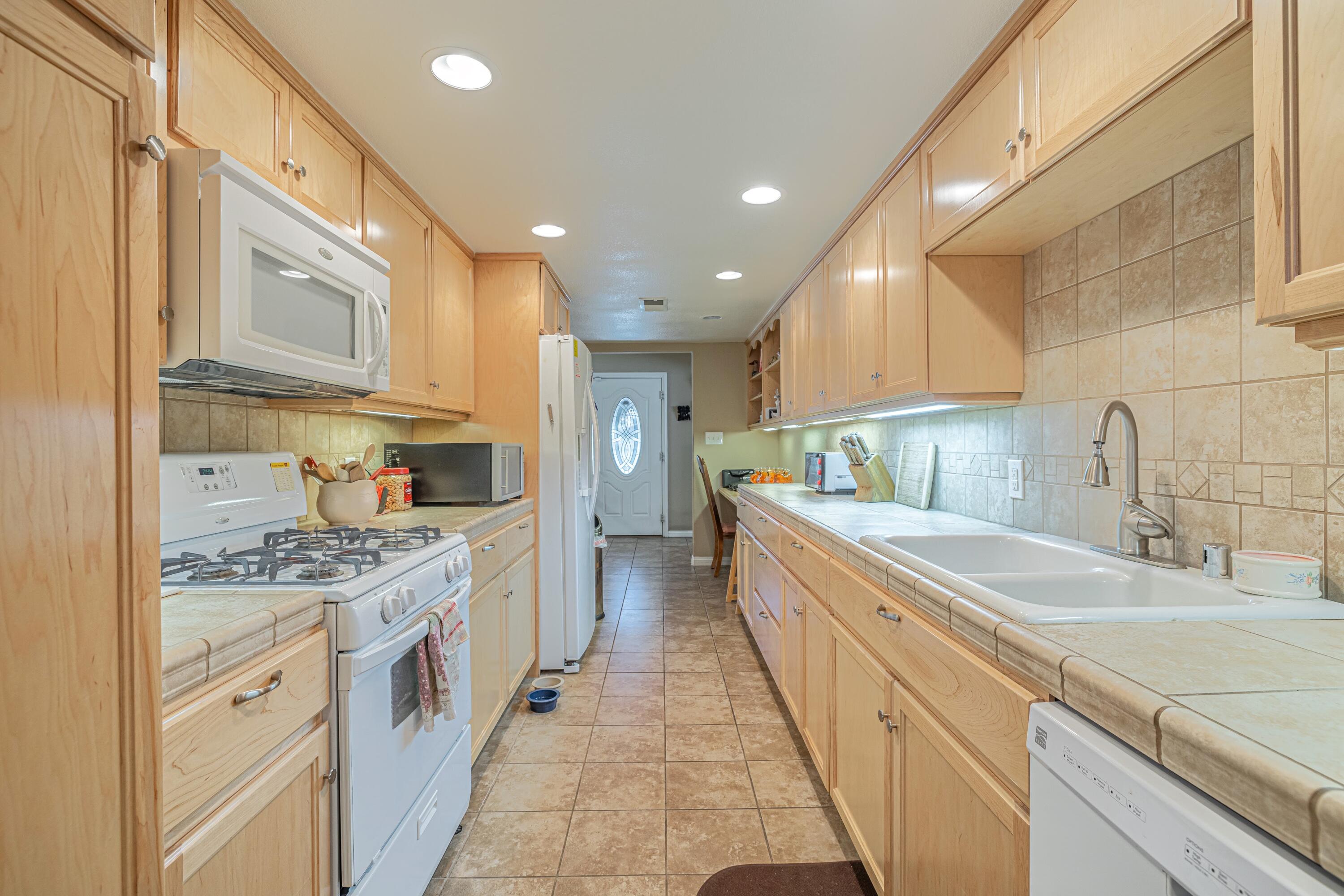 2153 West Ave K8 Lancaster, CA 93534 - Photo 12 of 31 a large kitchen with stainless steel appliances granite countertop a lot of counter space and a sink