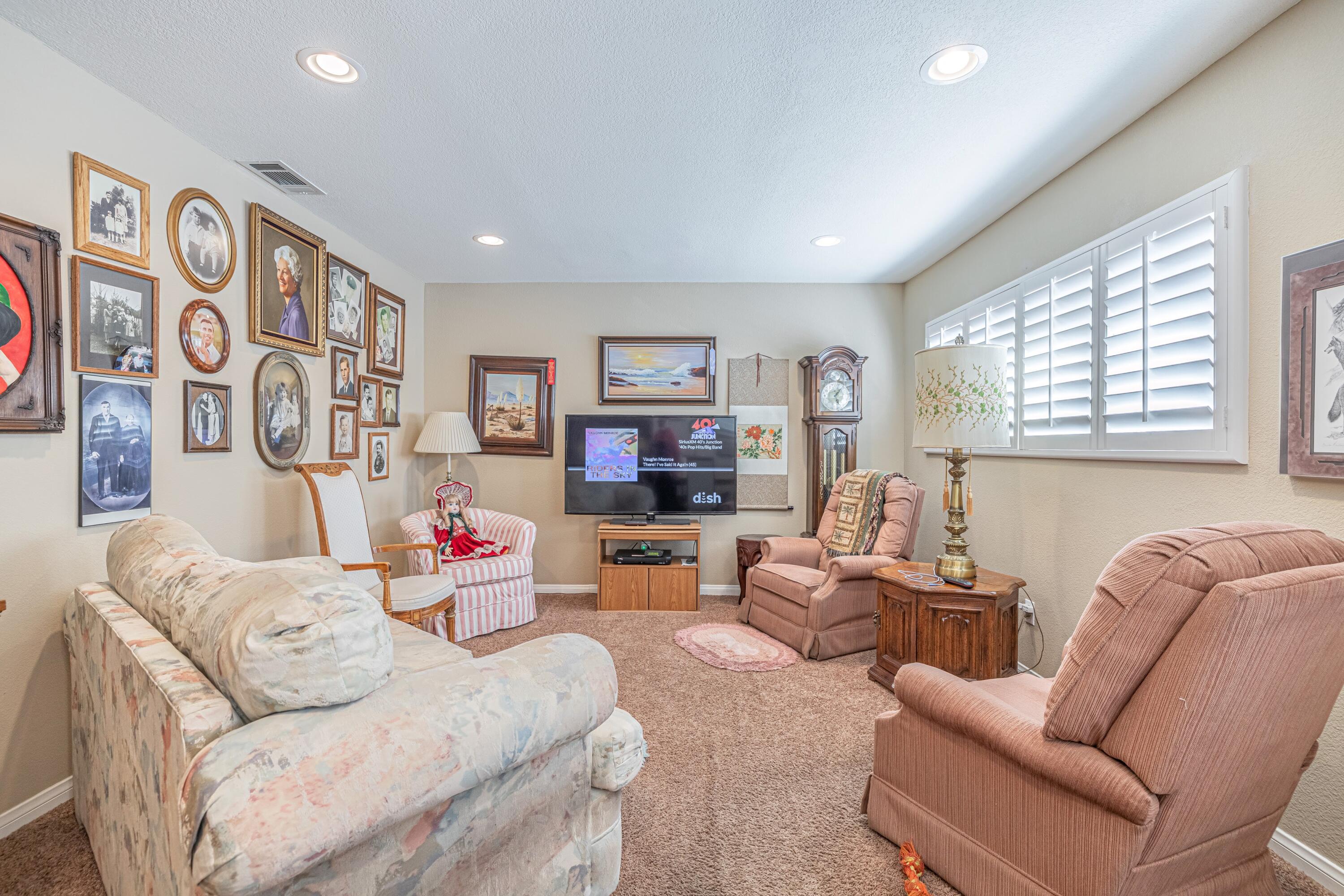 2153 West Ave K8 Lancaster, CA 93534 - Photo 16 of 31 a living room with furniture and a flat screen tv