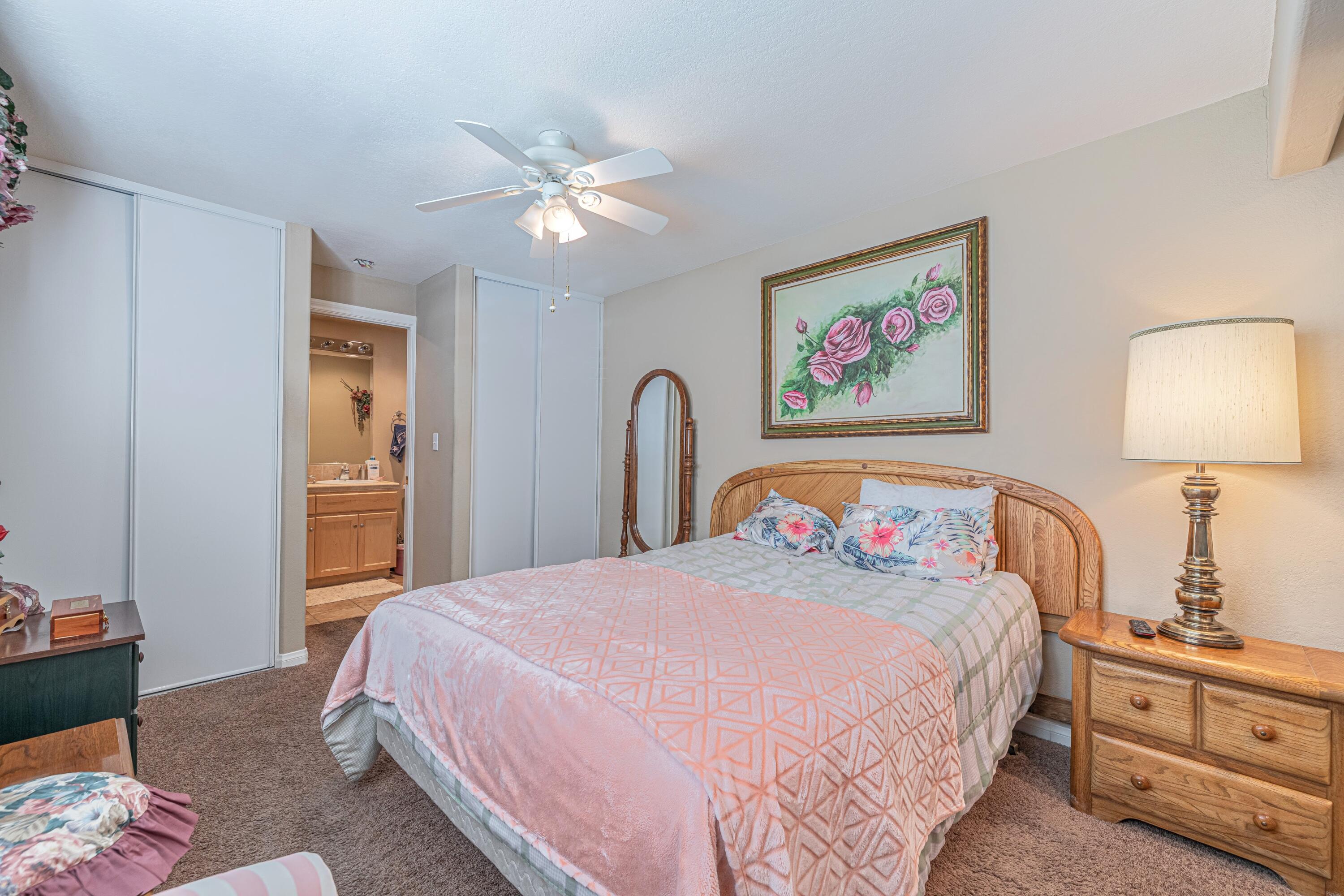 2153 West Ave K8 Lancaster, CA 93534 - Photo 19 of 31 a bedroom with a bed and a chandelier