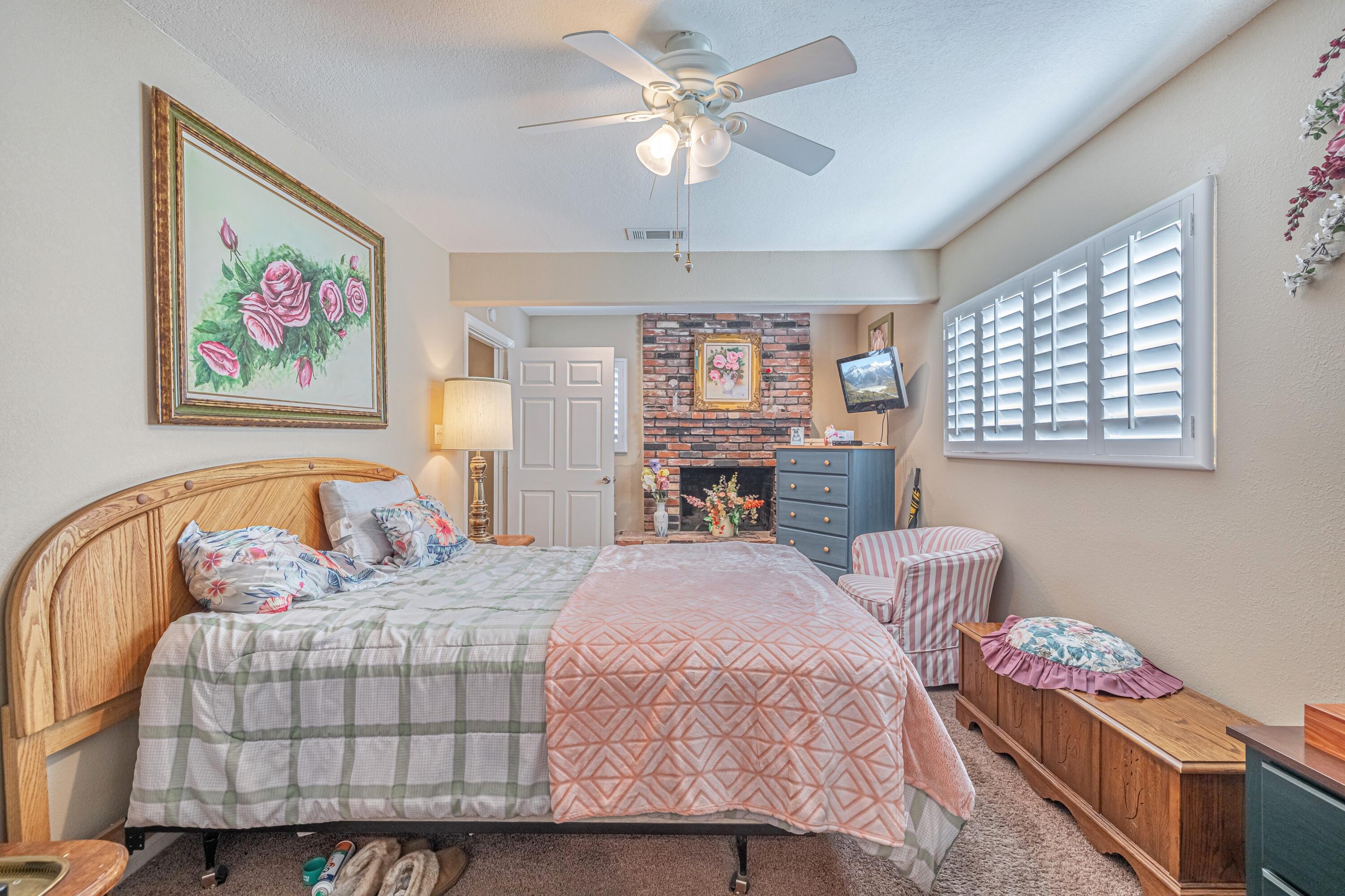 2153 West Ave K8 Lancaster, CA 93534 - Photo 20 of 31 a bedroom with a bed and a chandelier