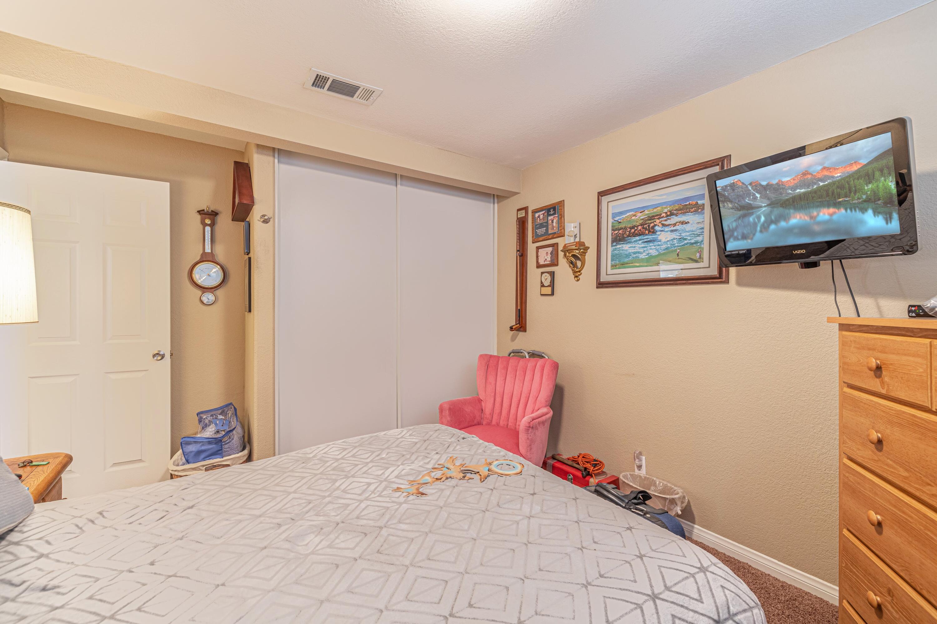 2153 West Ave K8 Lancaster, CA 93534 - Photo 23 of 31 a bedroom with a bed and a flat screen tv