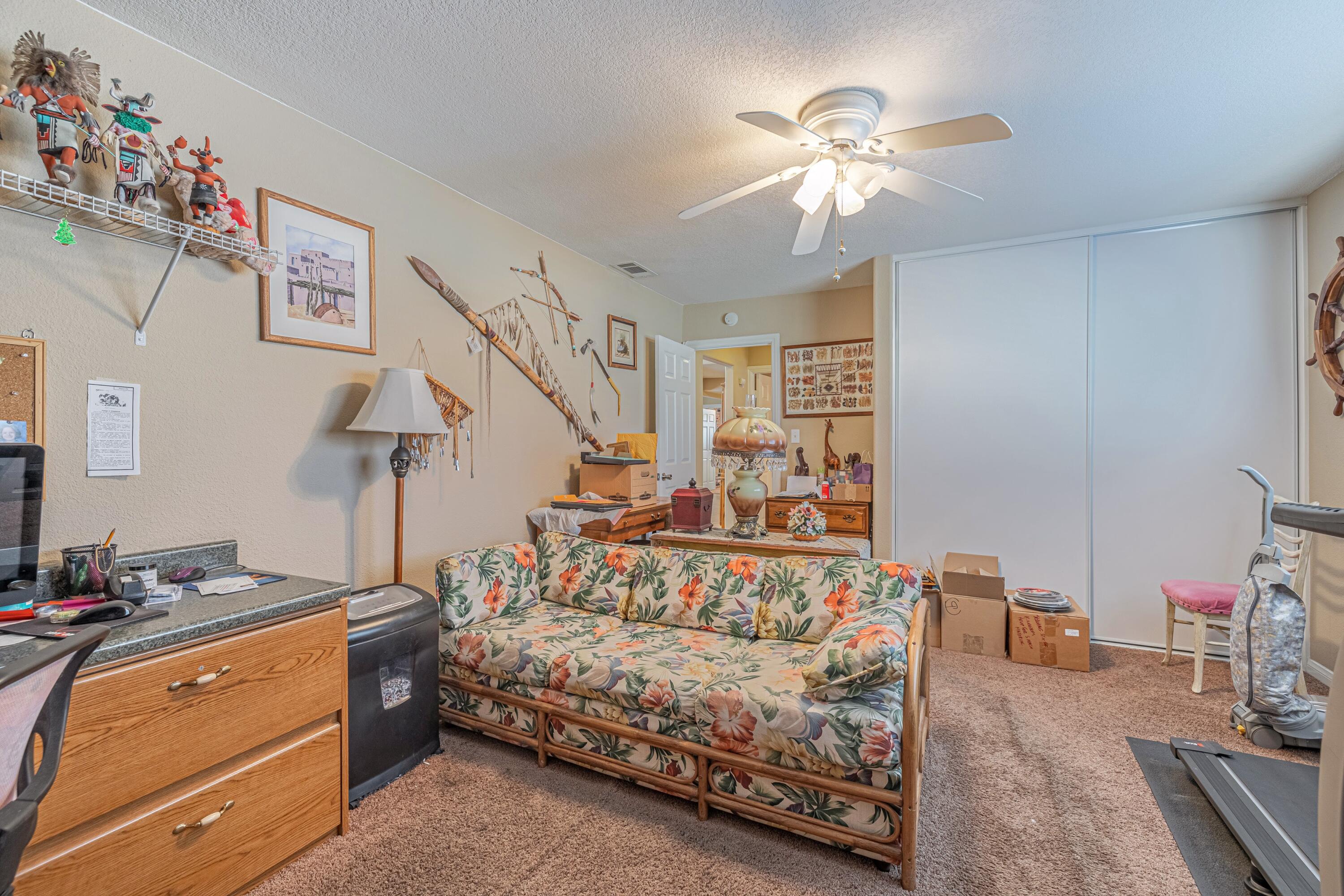 2153 West Ave K8 Lancaster, CA 93534 - Photo 25 of 31 a spacious bedroom with a bed and a chandelier