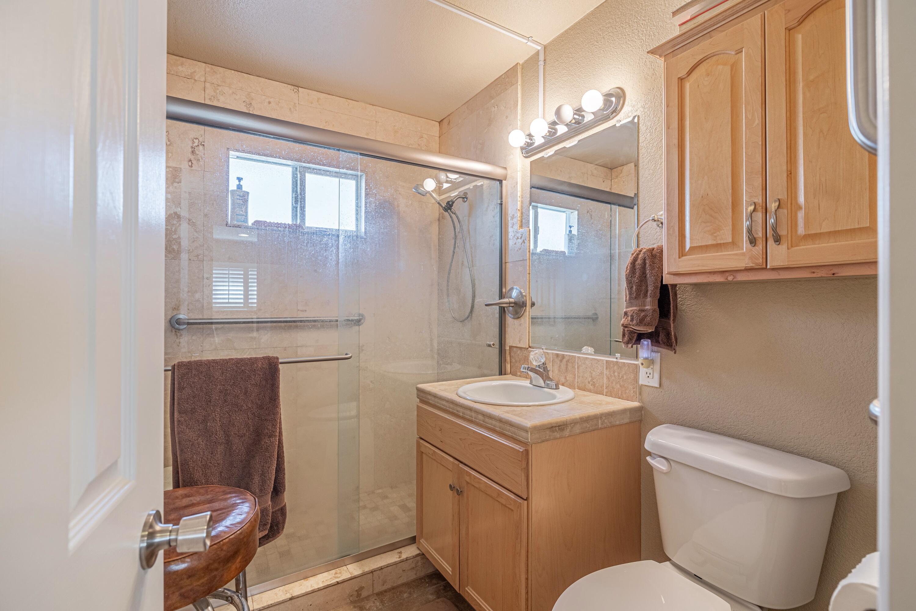 2153 West Ave K8 Lancaster, CA 93534 - Photo 26 of 31 a bathroom with a toilet sink and mirror