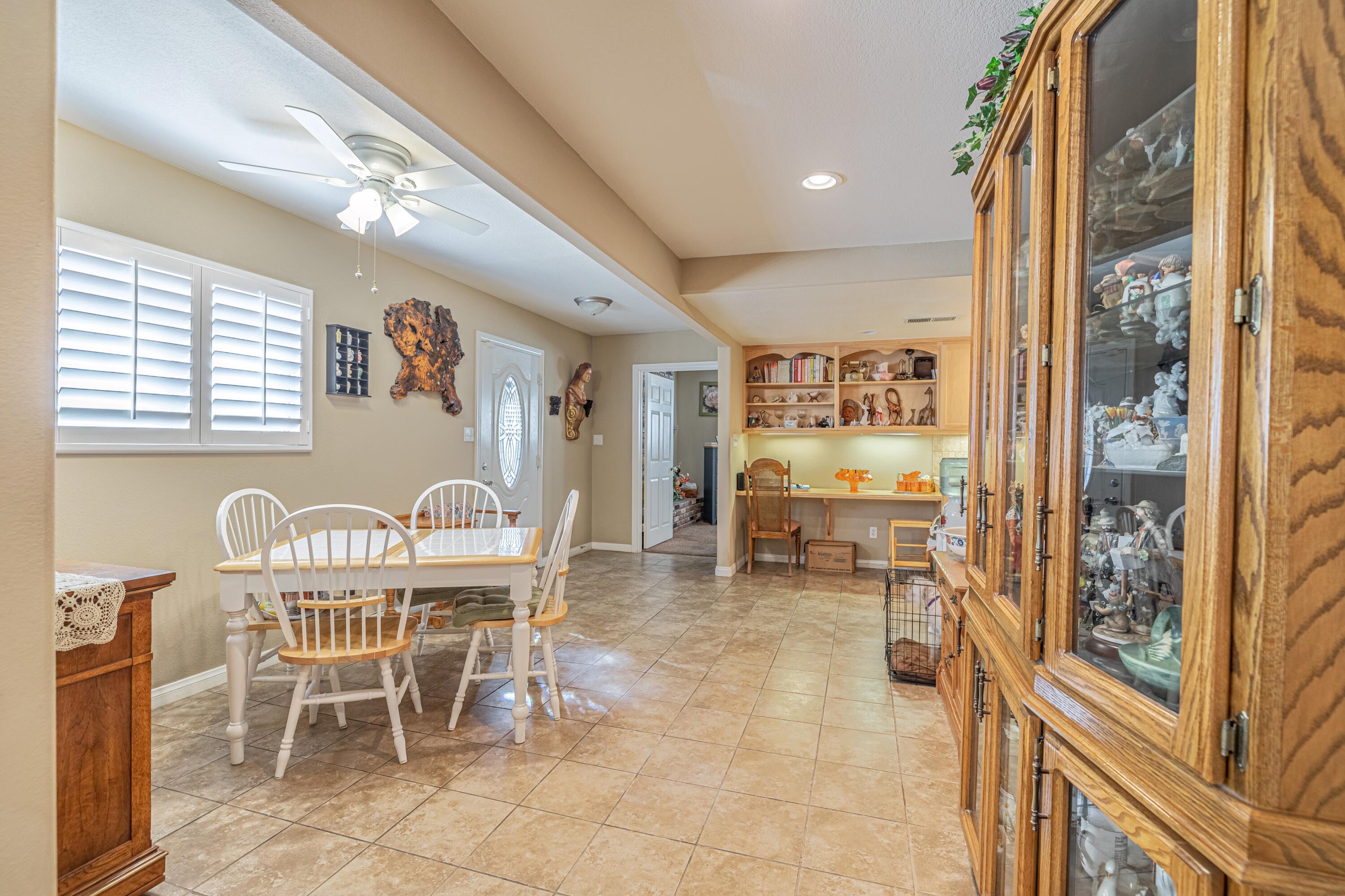 2153 West Ave K8 Lancaster, CA 93534 - Photo 6 of 31 a view of a dining room with furniture a chandelier and a large window