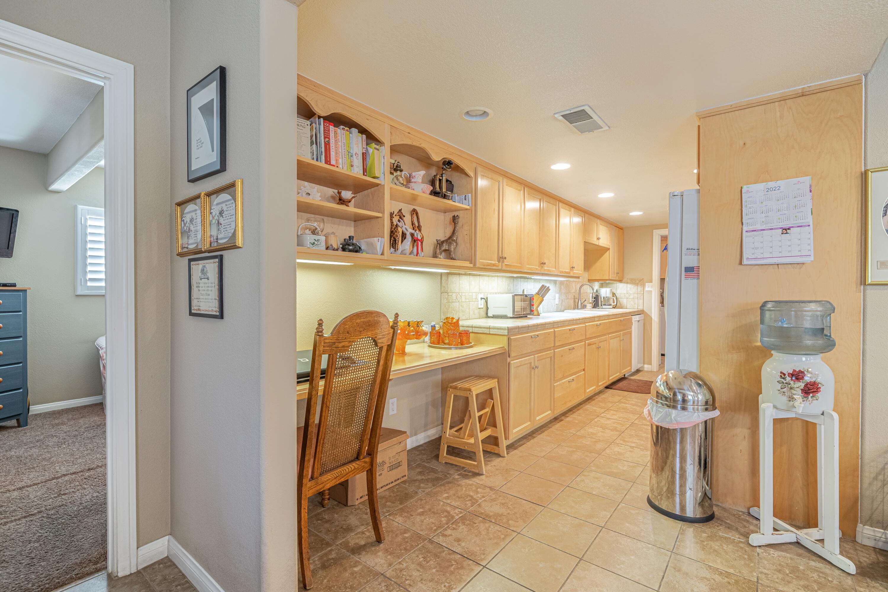 2153 West Ave K8 Lancaster, CA 93534 - Photo 8 of 31 a view of a hallway with dining area chandelier and entryway