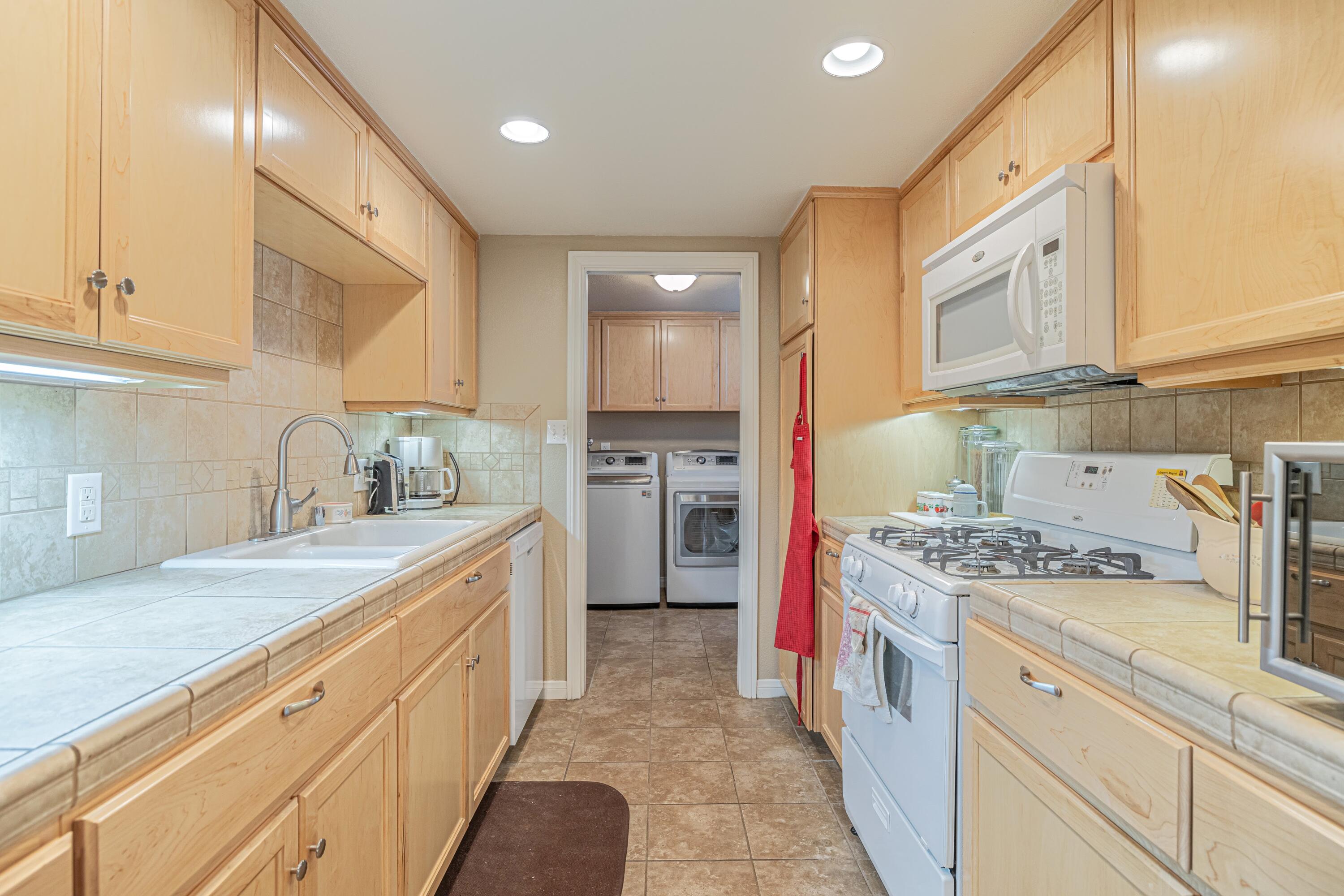 2153 West Ave K8 Lancaster, CA 93534 - Photo 10 of 31 a kitchen with stainless steel appliances granite countertop a sink stove and cabinets