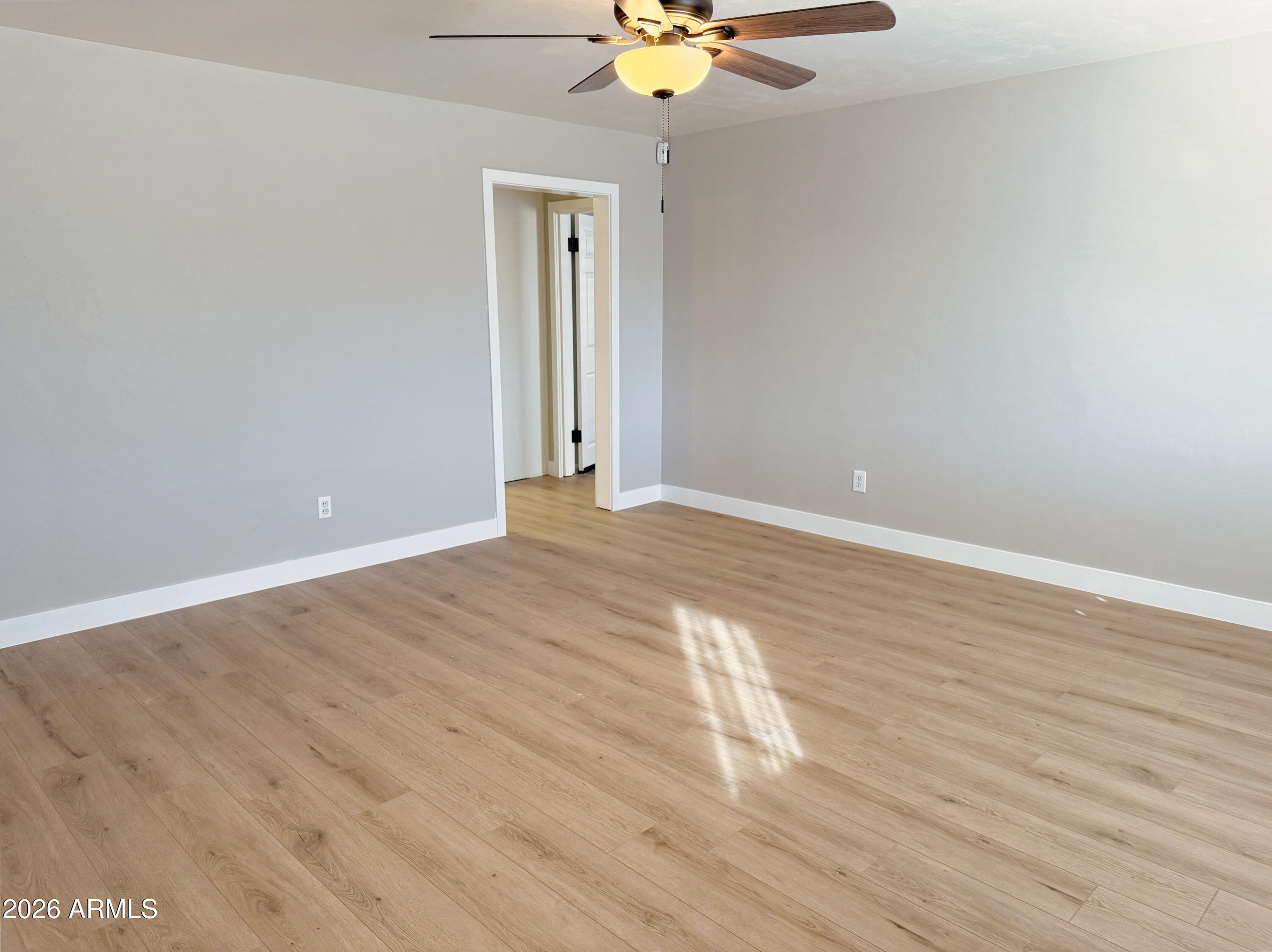 1220 West Romo Jones Street Tempe, AZ 85281 - Photo 3 of 26 a view of an empty room with a ceiling fan